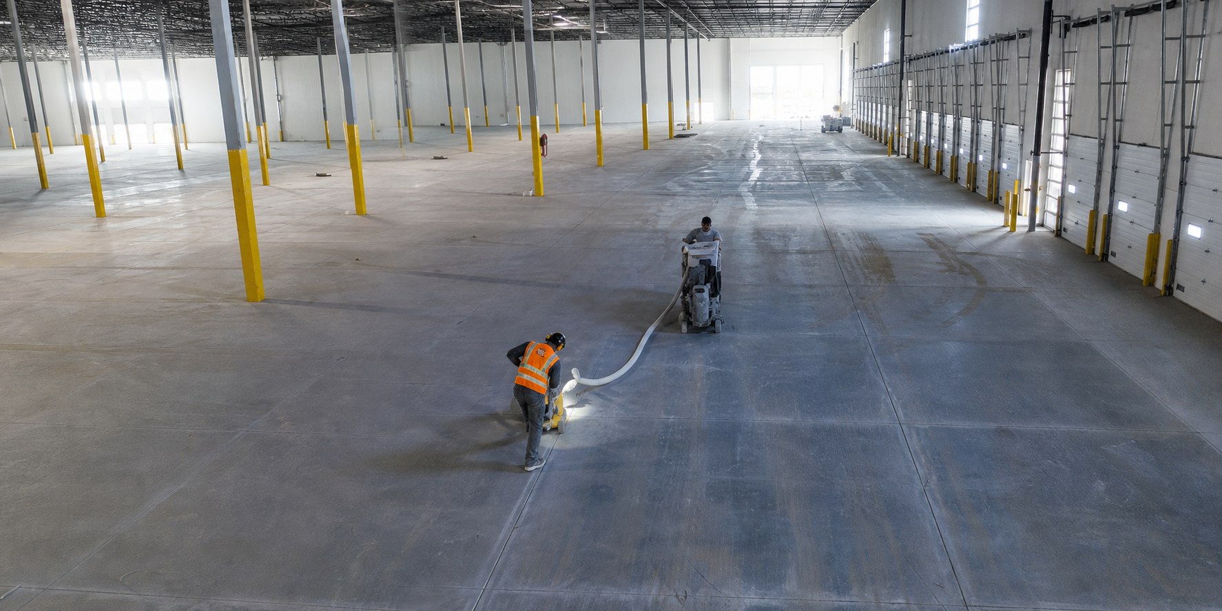 Concrete floor remediation in progress inside a warehouse