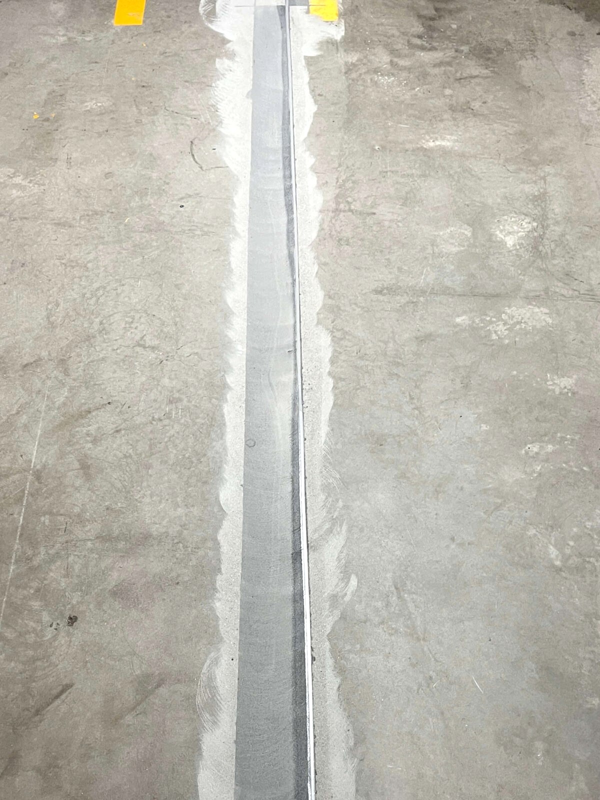 Concrete joint repair through a marked warehouse traffic lane